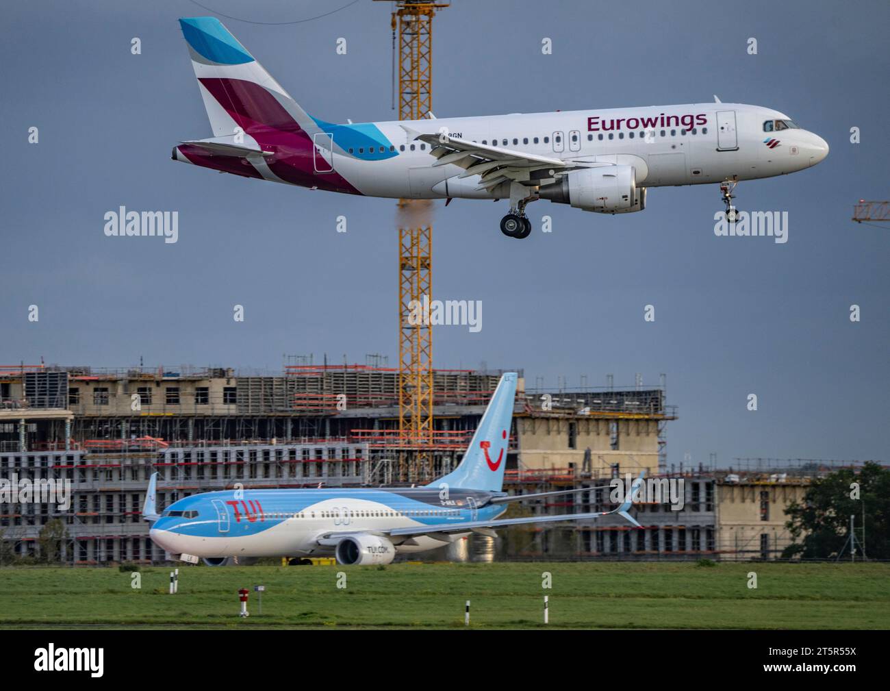 Eurowings, Airbus A319-100, D-ABGN, landing at Düsseldorf International Airport, TUIfly Boeing 737 waiting for take-off, Stock Photo