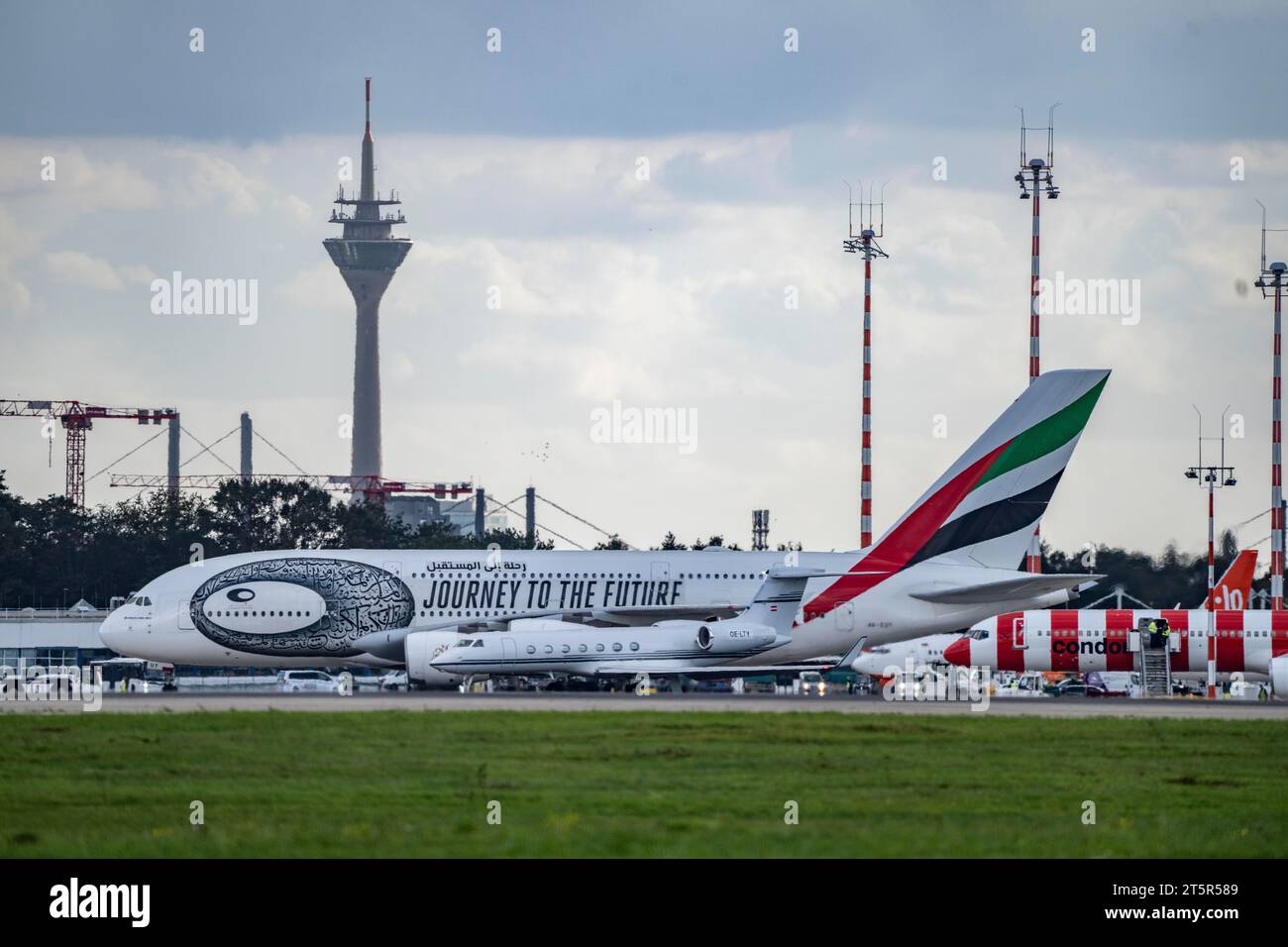 Düsseldorf International Airport, Emirates, Airbus A380-800, A6-EUT, Alpi Jets, Gulfstream G550, OE-LTY, on the taxiway for take-off, Rhine Tower, Stock Photo