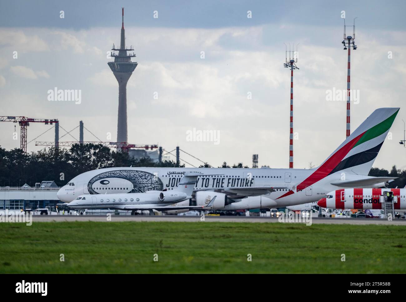 Düsseldorf International Airport, Emirates, Airbus A380-800, A6-EUT, Alpi Jets, Gulfstream G550, OE-LTY, on the taxiway for take-off, Rhine Tower, Stock Photo
