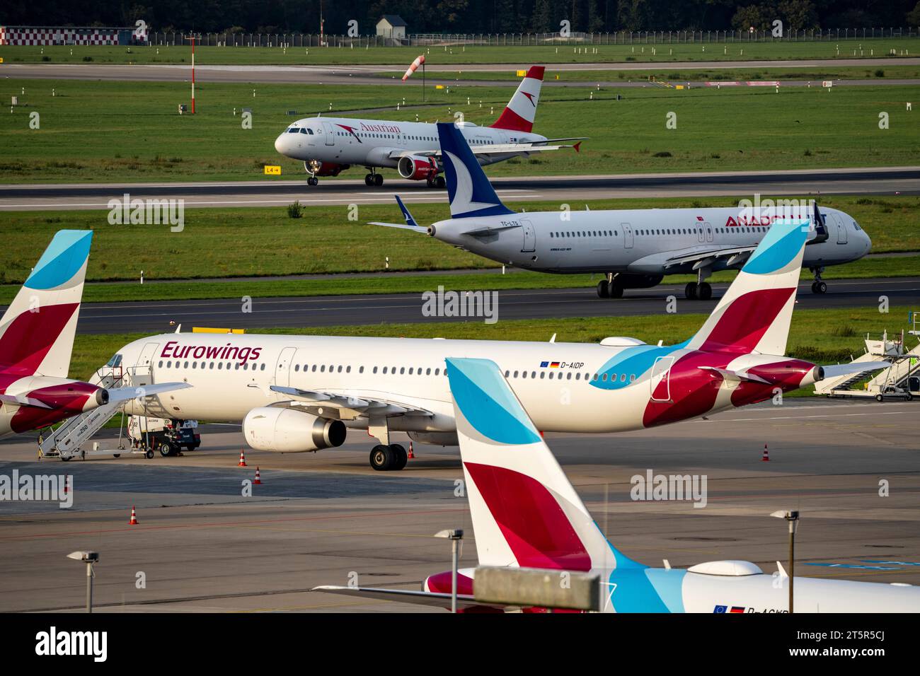 Düsseldorf Airport, Anadolujet aircraft on the taxiway, Eurowings Airbus in parking position, Austrian Airbus landing, Stock Photo