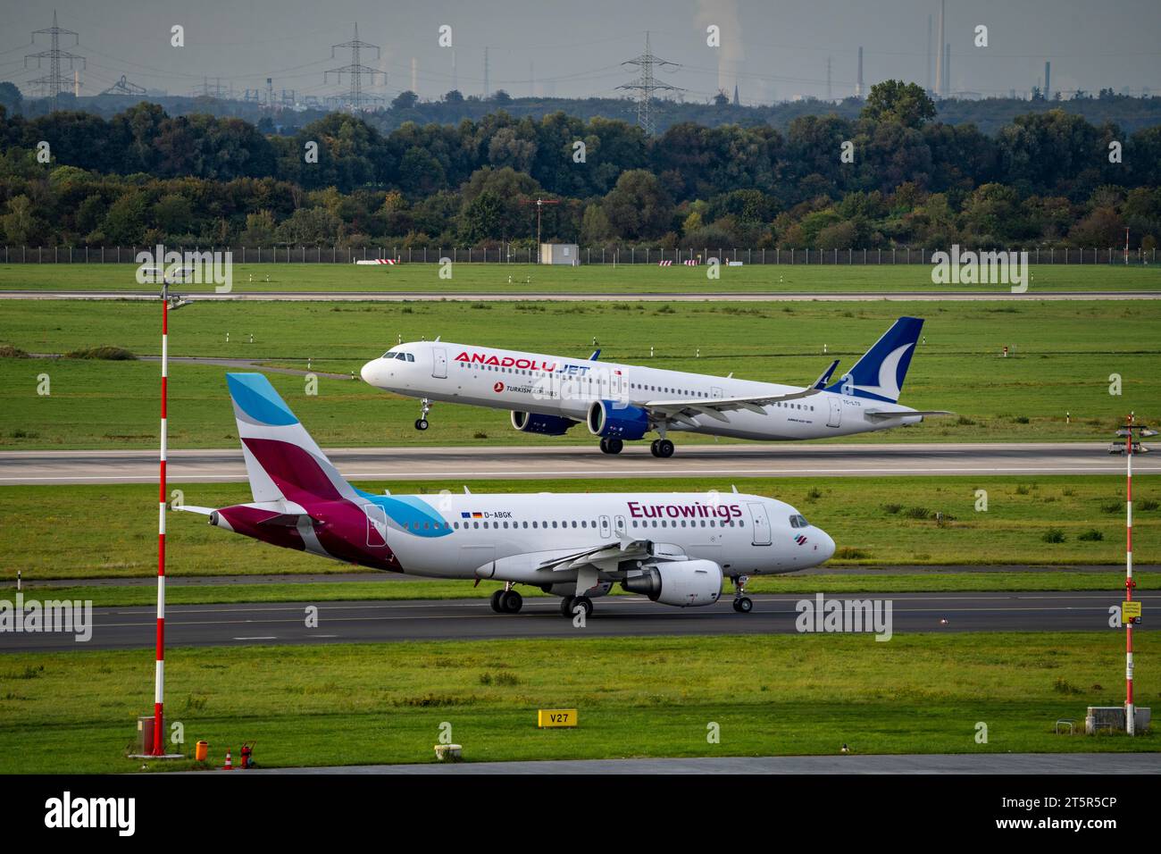 Düsseldorf Airport, Anadolujet aircraft taking off, Eurowings Airbus on the taxiway for take-off, Stock Photo
