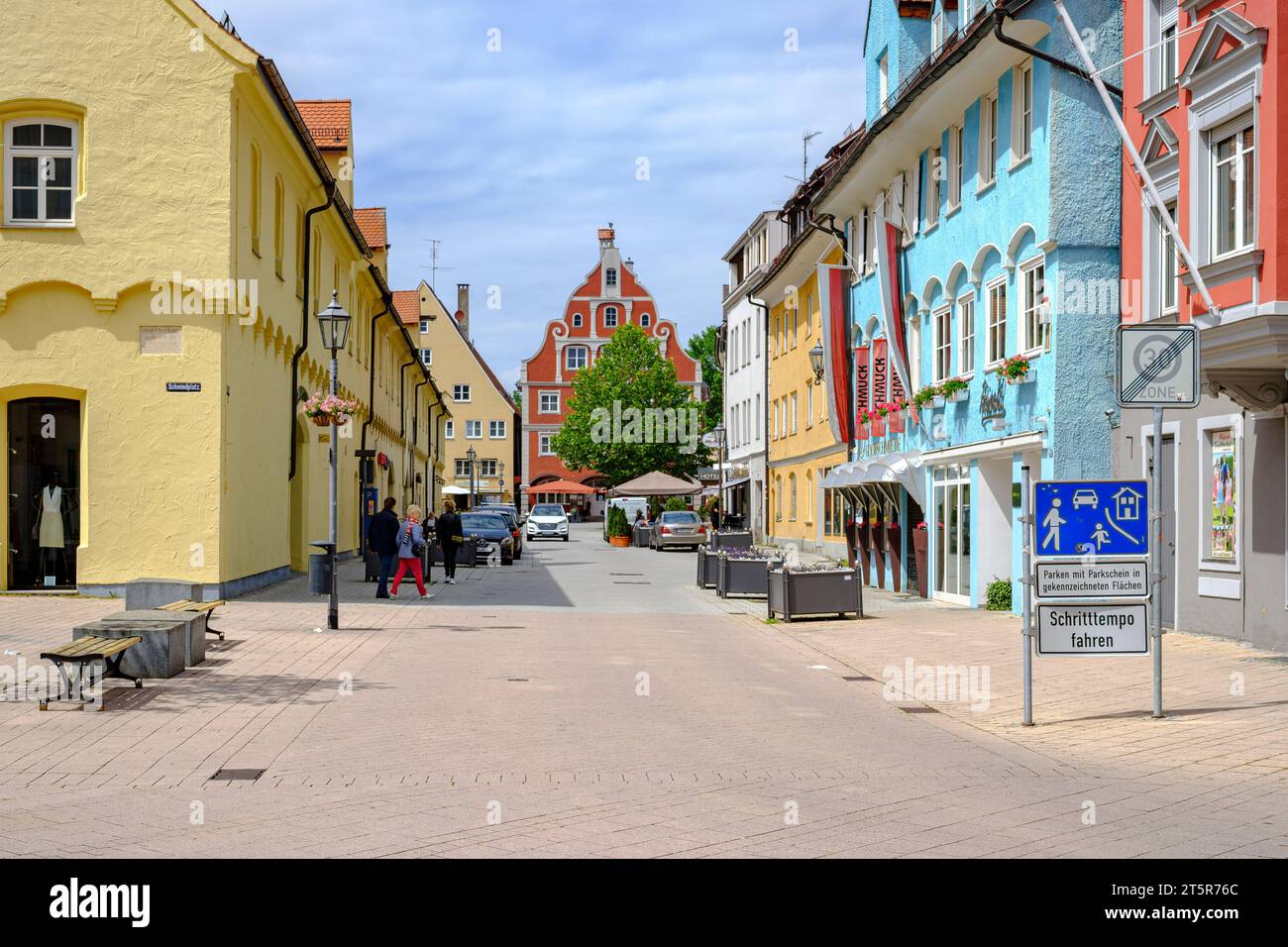 Lively everyday scene in front of a historic architectural backdrop in the Old Town of Memmingen, Swabia, Bavaria, Germany. Stock Photo
