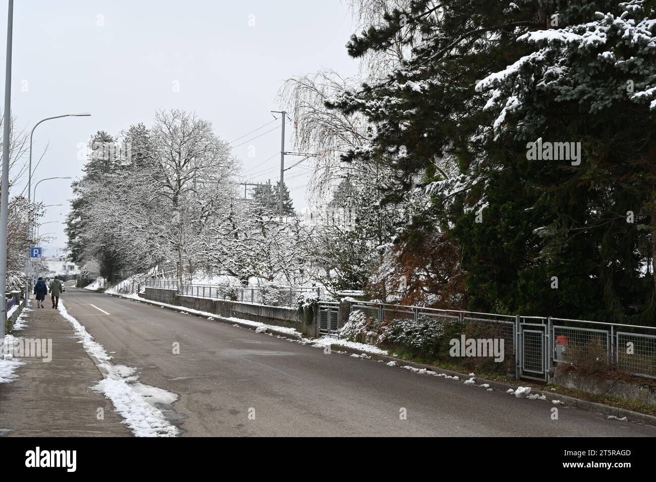 Street in residential quarter of village Urdorf in Switzerland in winter. Stock Photo