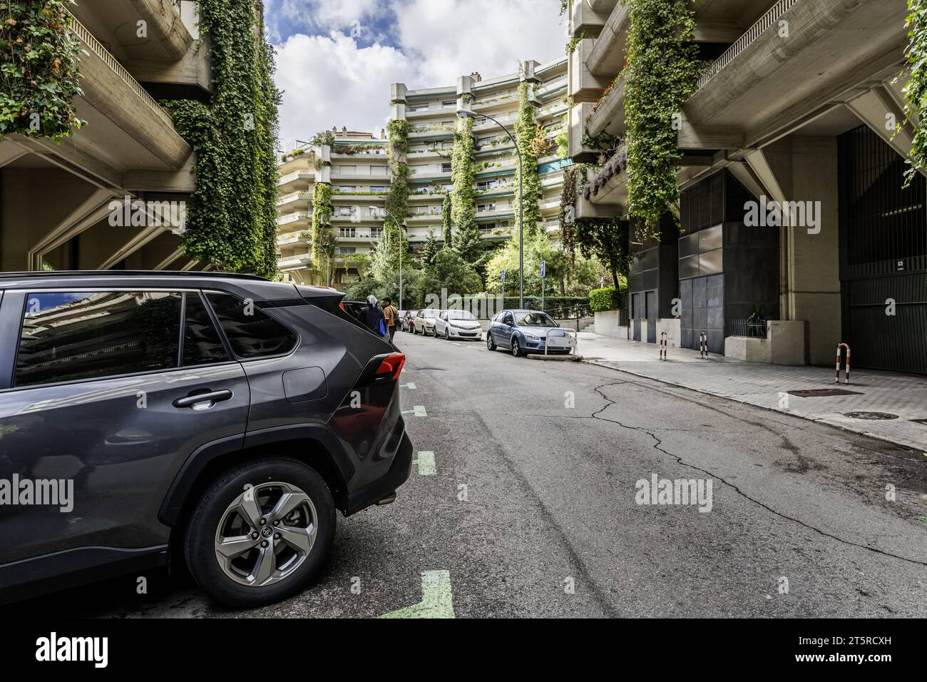 Facades of several residential buildings built of concrete with hanging gardens on the balconies Stock Photo