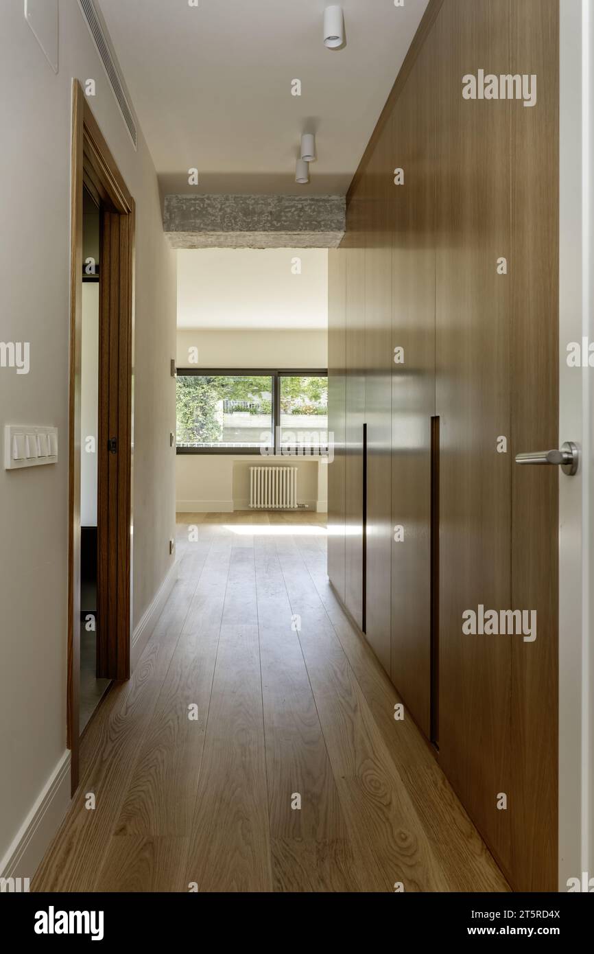 Access hallway to an en-suite bedroom with built-in oak wardrobes Stock Photo