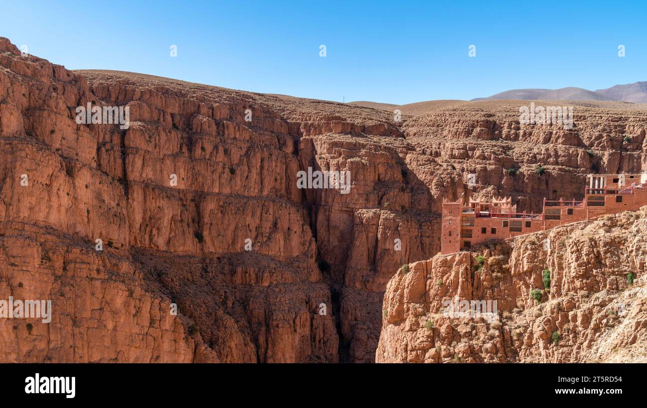 Hotel at the top of Dades Gorges, a series of canyons formed by the Dades River. Red and orange rock formations create a dramatic and picturesque land Stock Photo