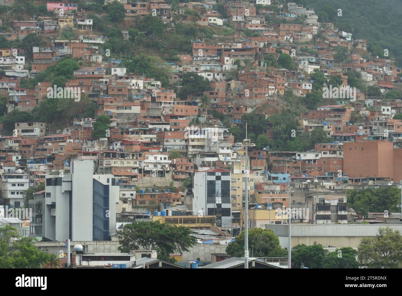 Suburb of La Guaira town near Caracas with poor family houses  showing poverty and is situated on hill near commercial merchant port. Stock Photo
