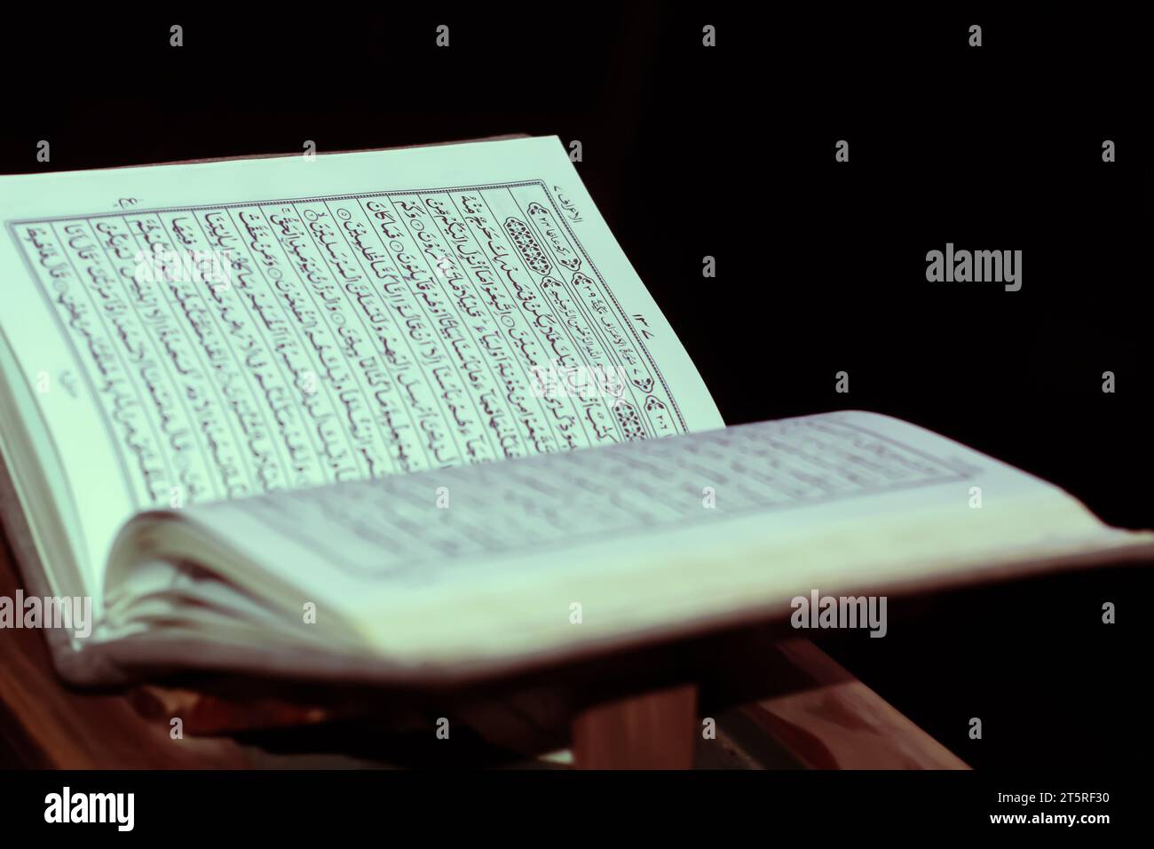 Quran open with black background verse al aaraaf Stock Photo