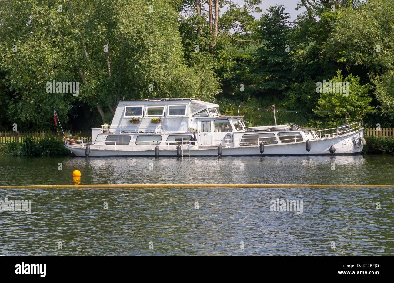 14 June 23 A beautiful motor cruiser berthed on the Thames at Henley-on-Thames in Oxfordshire, the venue for the Royal Regatta, on a fine summer after Stock Photo