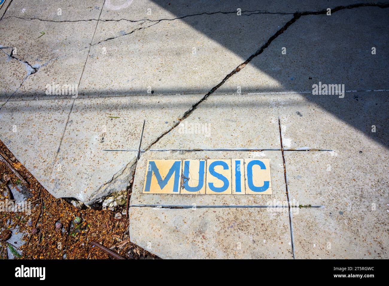 Music Street tile inlay sign, which has been cut for removal, on the sidewalk in the Faubourg Marigny neighborhood of New Orleans, Louisiana, USA Stock Photo