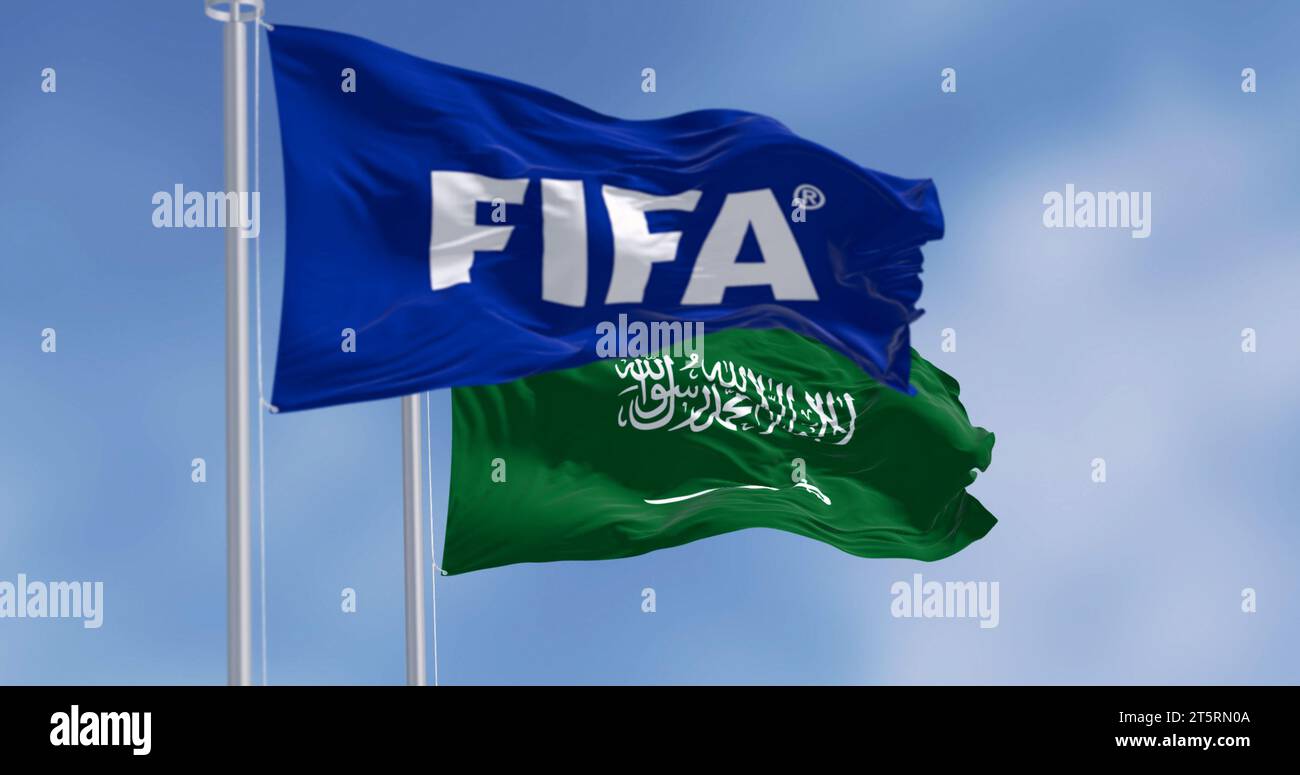 Zurich, CH, Nov. 4 2023: FIFA and Saudi Arabian flags waving in the wind. Saudi Arabia will host the 25th edition of the FIFA World Cup 2034. Illustra Stock Photo