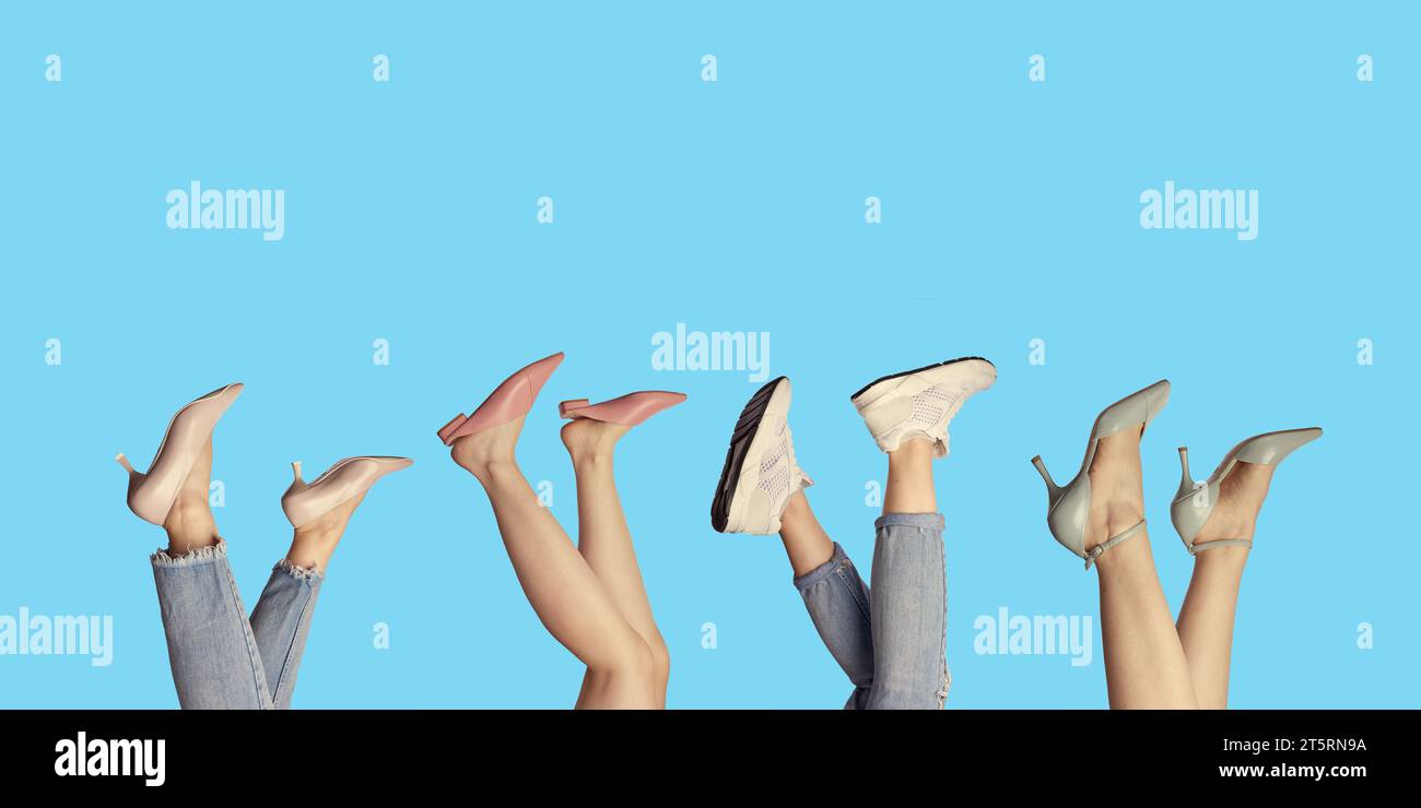 Creative banner of woman's legs showcasing modern summer shoes, isolated on a bright blue background with copy space. Stock Photo