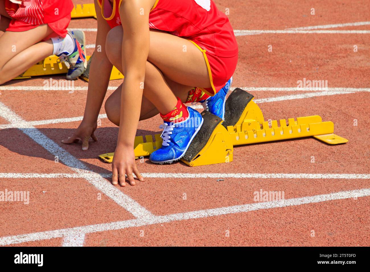 yellow starting block and athletes, closeup of photo Stock Photo - Alamy