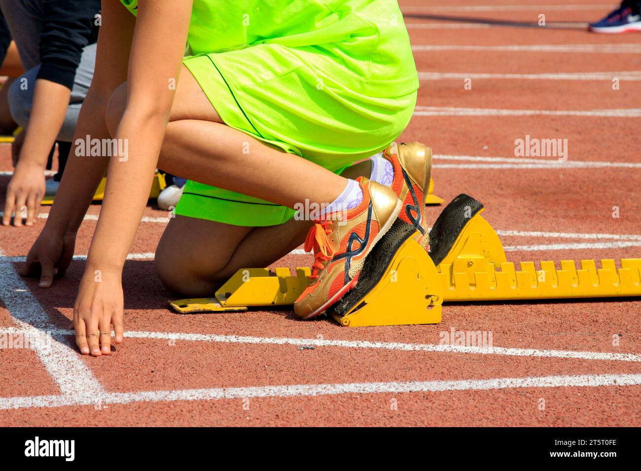 yellow starting block and athletes, closeup of photo Stock Photo - Alamy