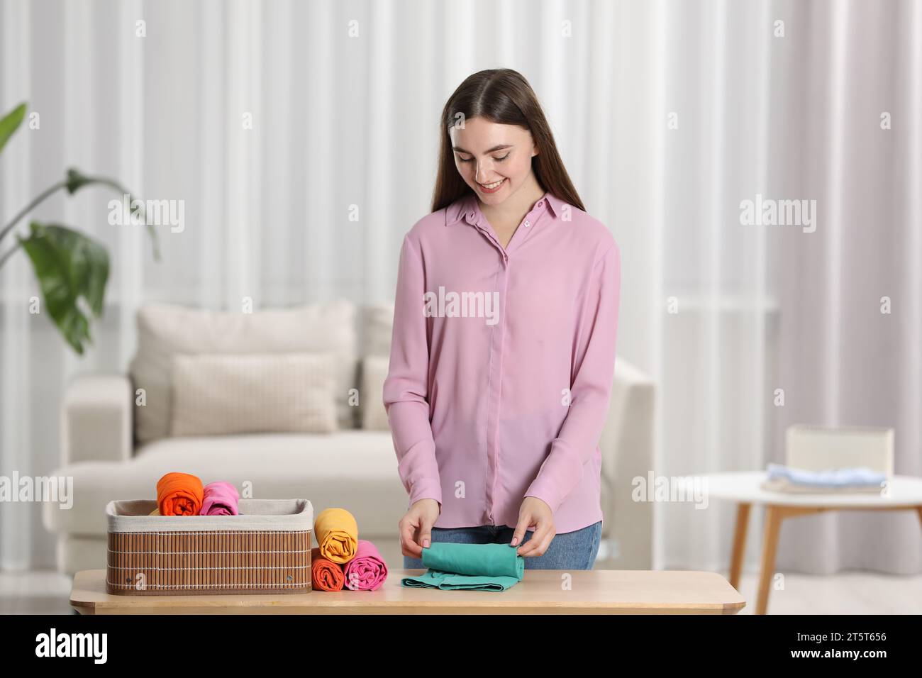 A close-up of a woman potter rolls a brown clay rolling pin on a special  fabric on a wooden table to make a plate and New Year's toys, on the table  li