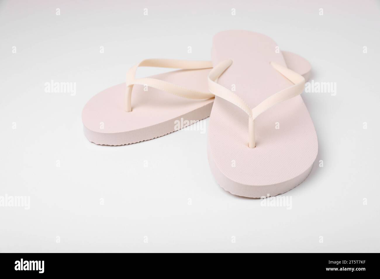 Pair of stylish flip flops on white background Stock Photo - Alamy