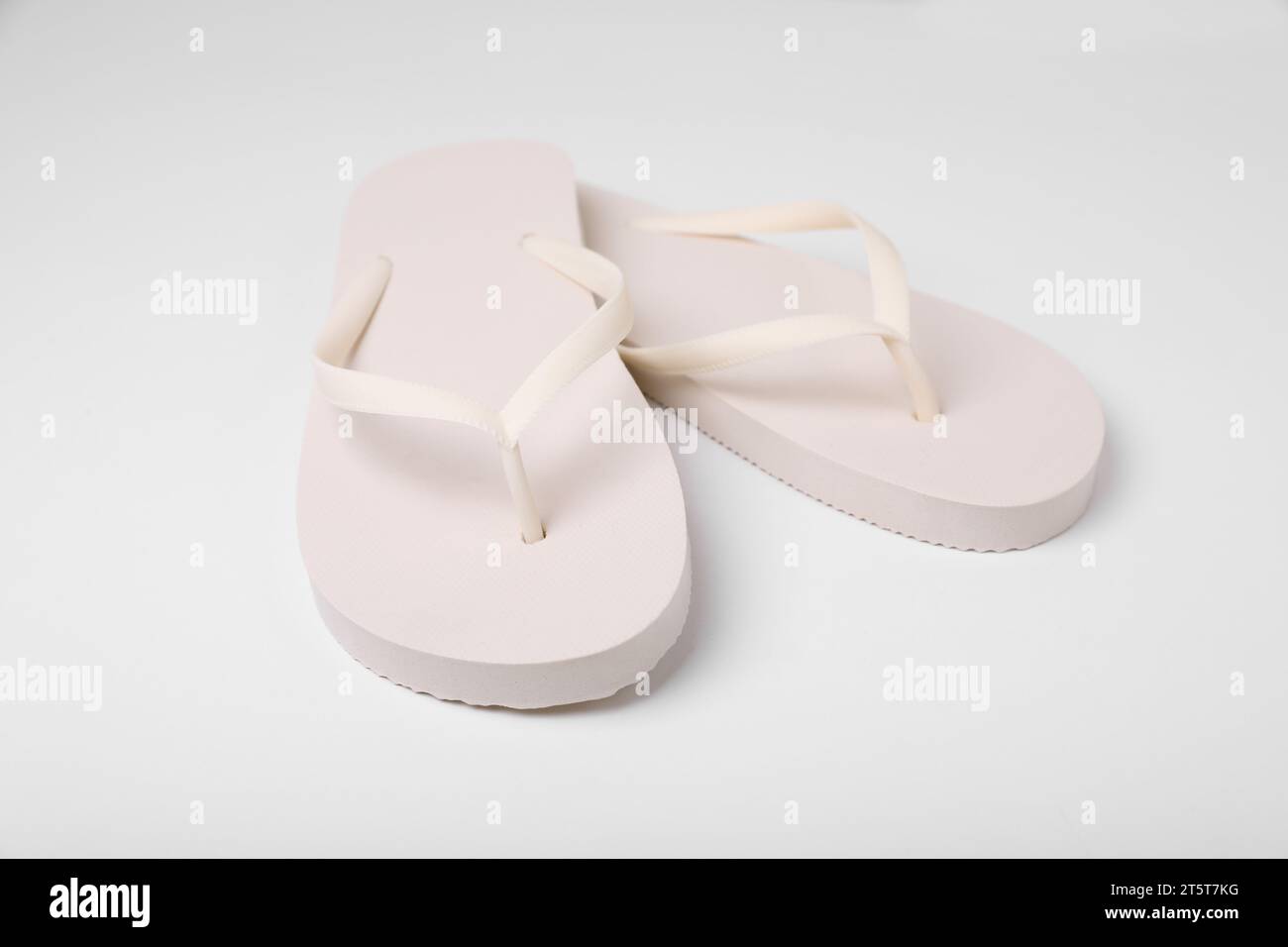Pair of stylish flip flops on white background Stock Photo - Alamy