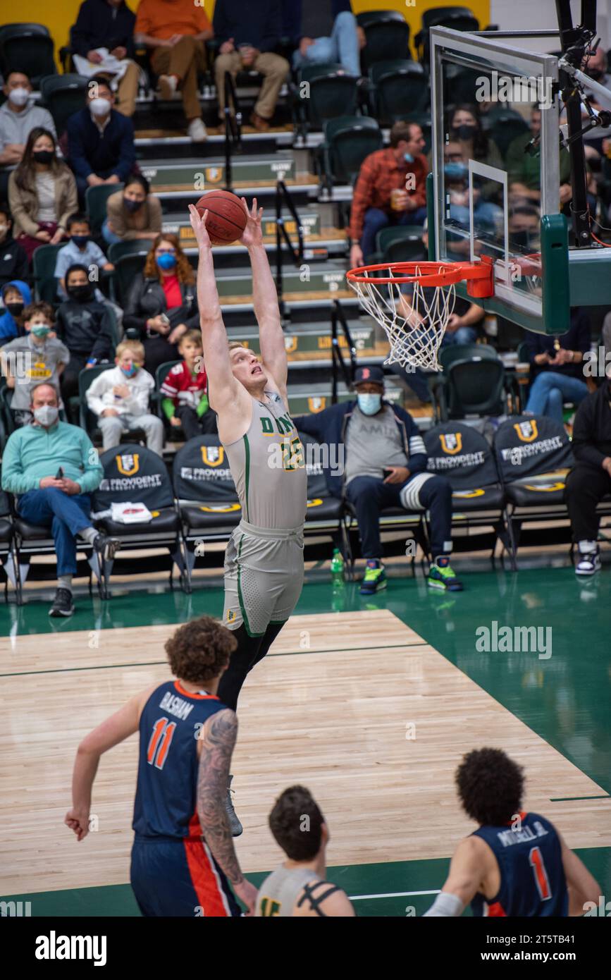 A college Basketball player slams down a dunk Stock Photo