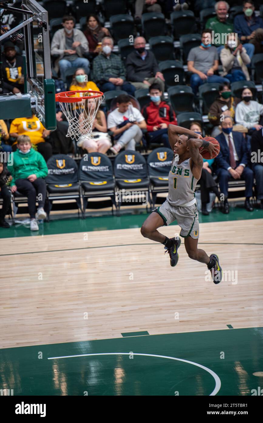 College basketball player driving to the rim for a layup during NCAA ...