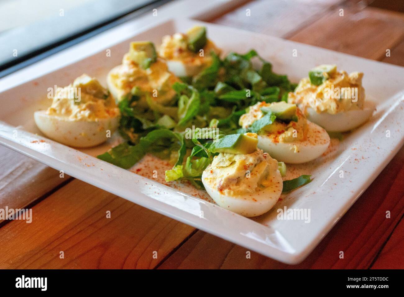 Deviled Eggs Topped with Avocado Appetizer Stock Photo