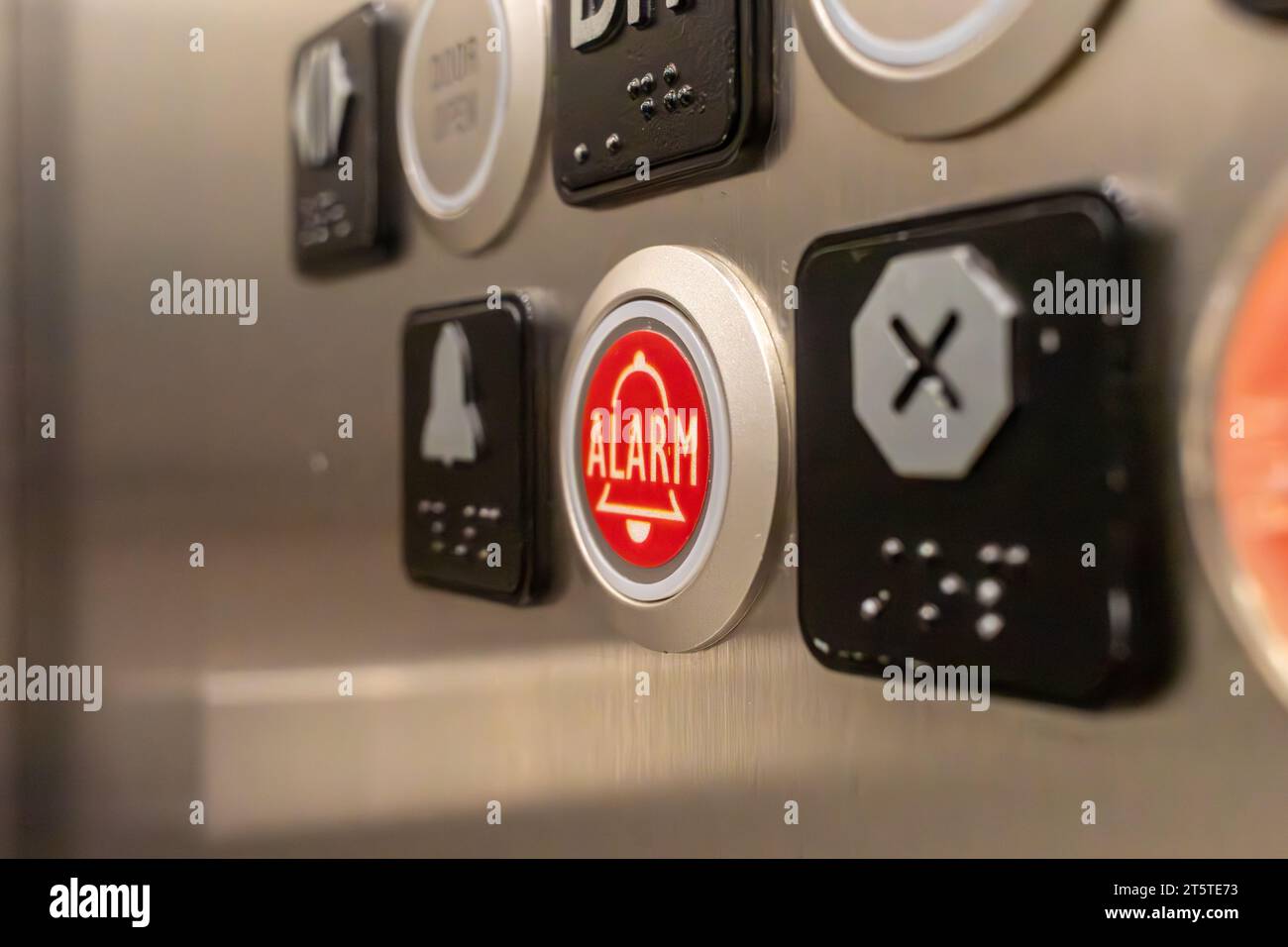 Elevator alarm button closeup of red alarm button on elevator