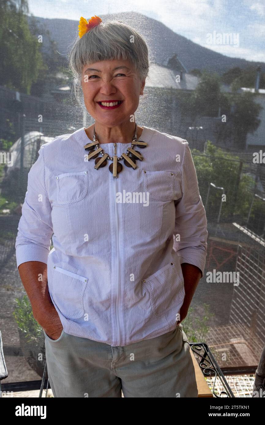 A smiling happy 68 year old Australian Chinese Italian Eurasian woman Stock Photo