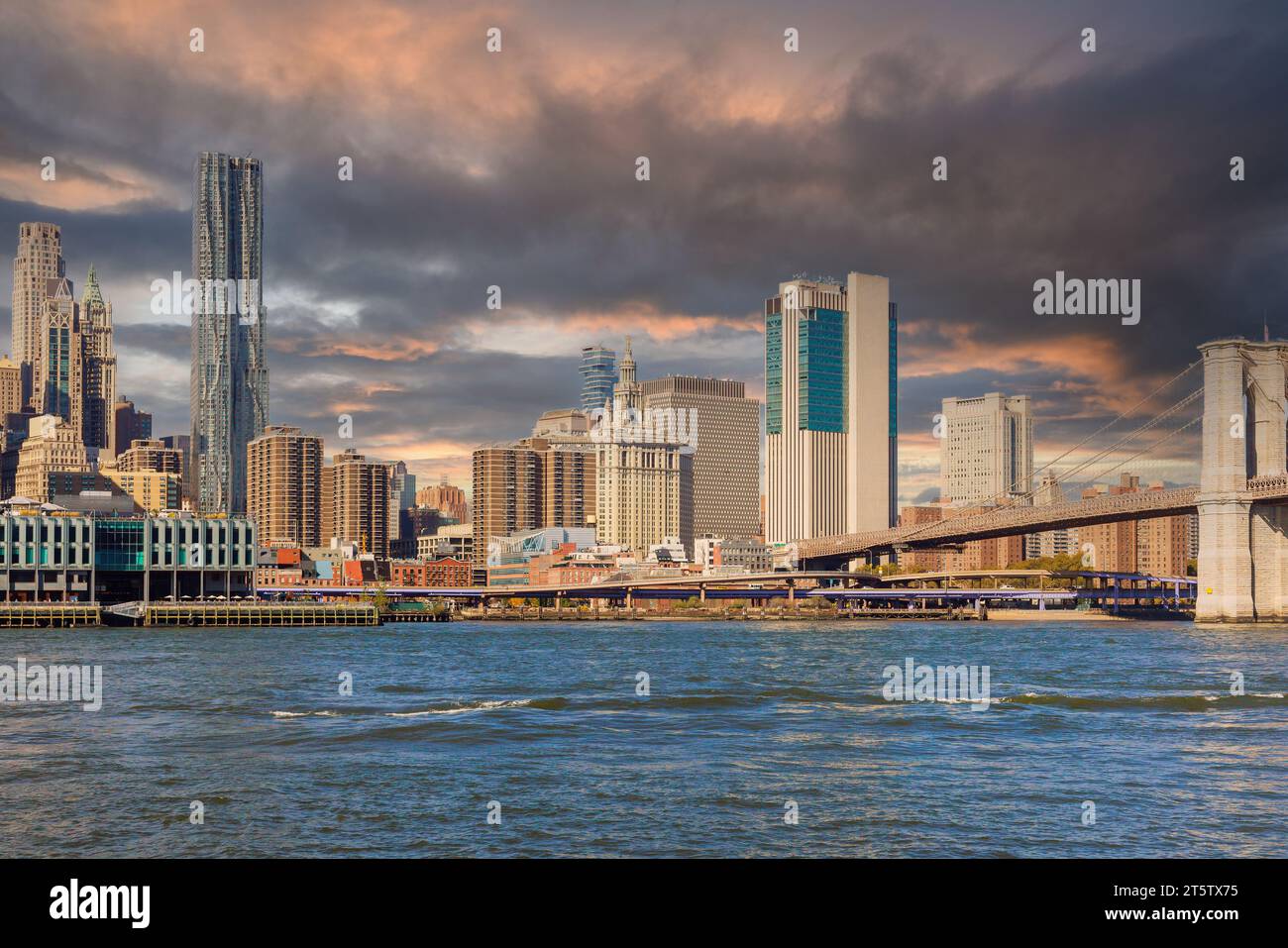 New York City skyline across East River looking at Brooklyn Bridge ...