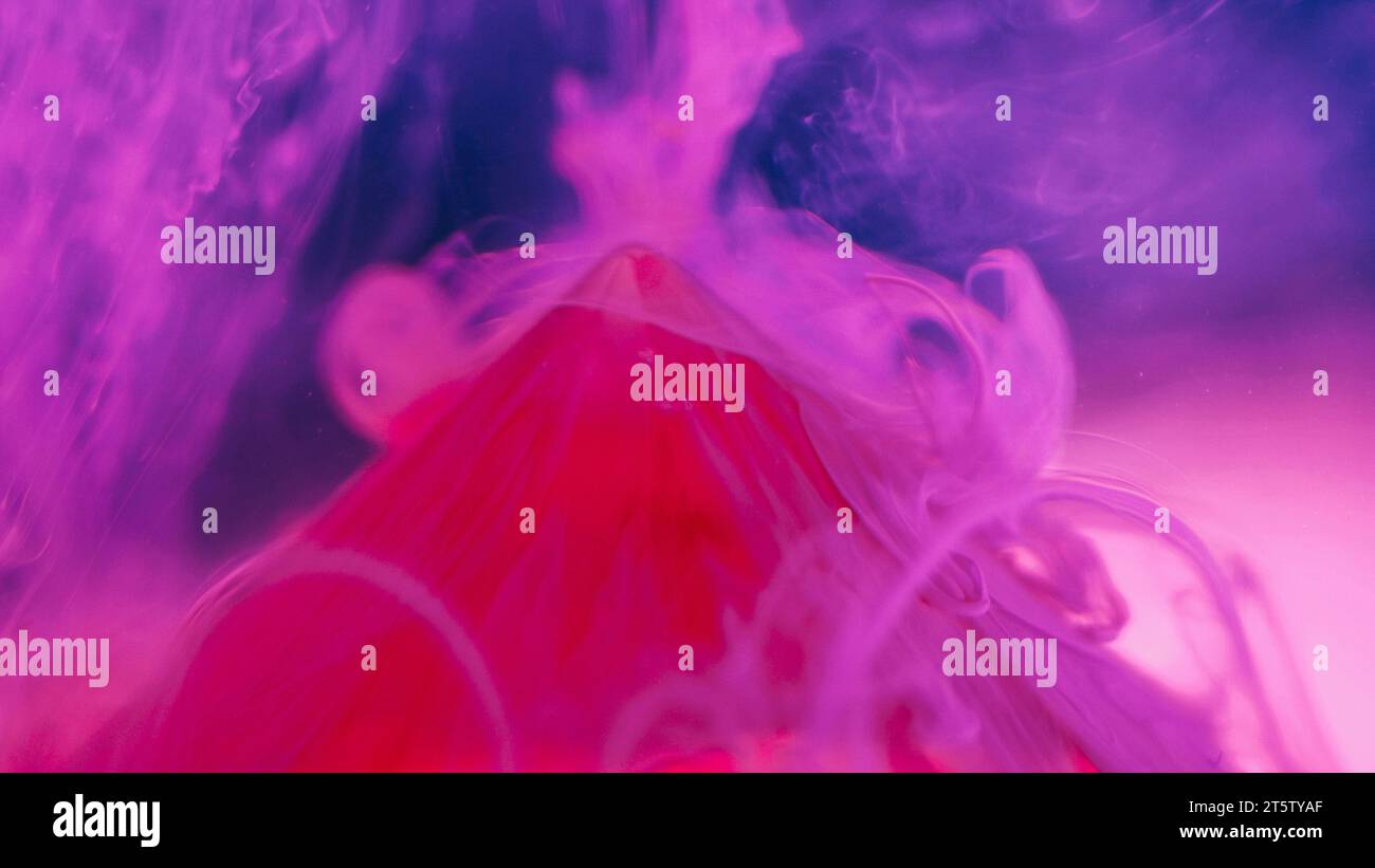 Ink water background pink pyramid top particles Stock Photo - Alamy