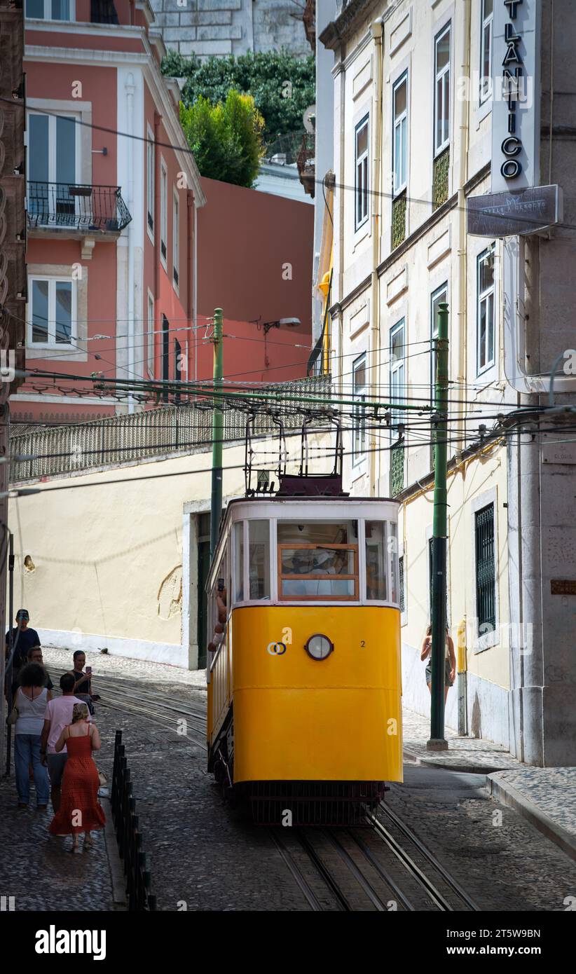 Gloria Funicular, Ascensor da Glória, Lisbon, Portugal. The Glória funicular, public tram, leaving Restauradores Square on Avenue da Liberdade in central Lisbon to climb a 17.7% grade 265 meters (870 ft) to the Miradouro de São Pedro de Alcântara a viewpoint in the Principe Real neighborhood overlooking Lisbon. Stock Photo