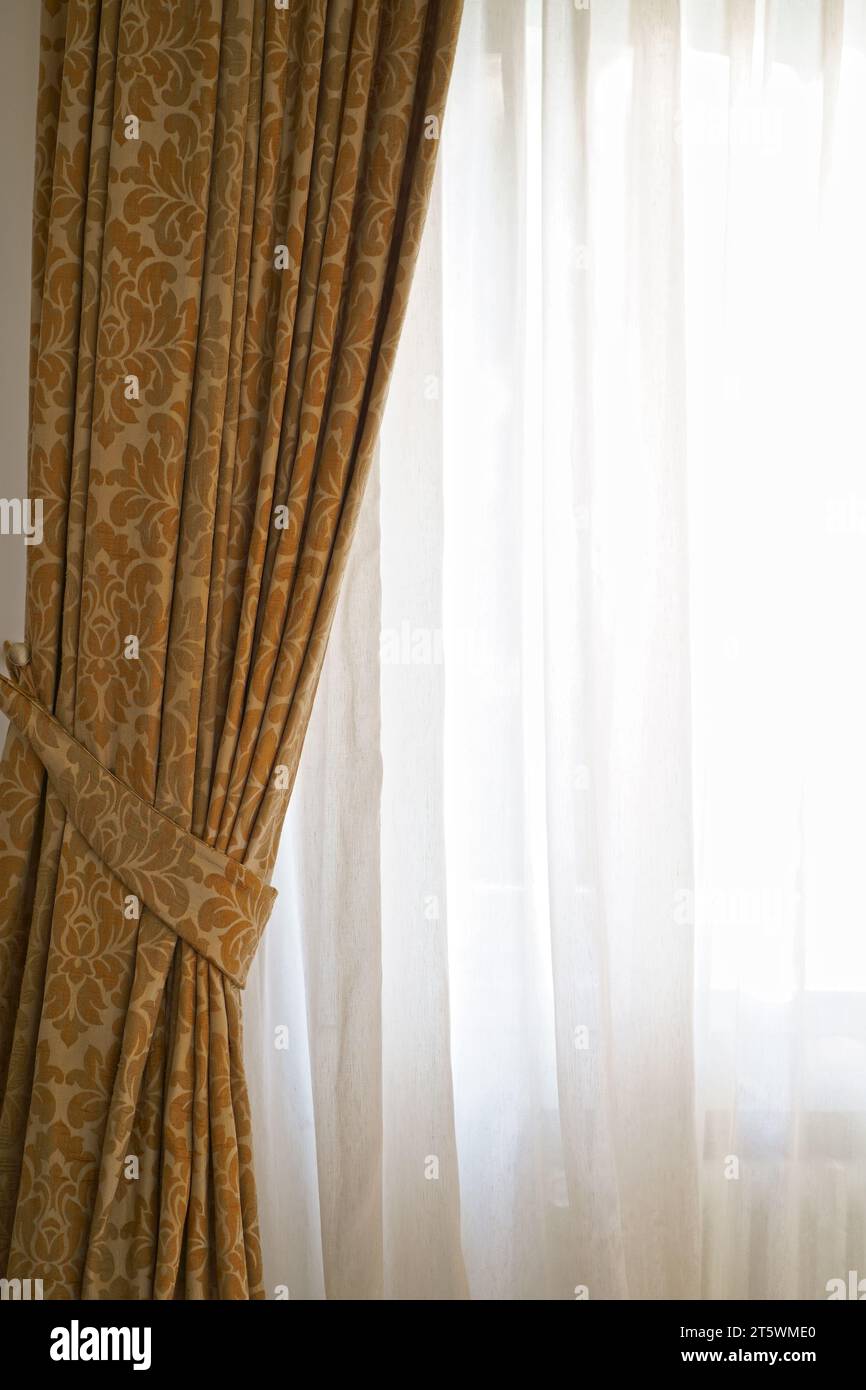 Beautiful brown curtains with a pattern. eautiful curtains that would be the perfect addition to any home. Stock Photo