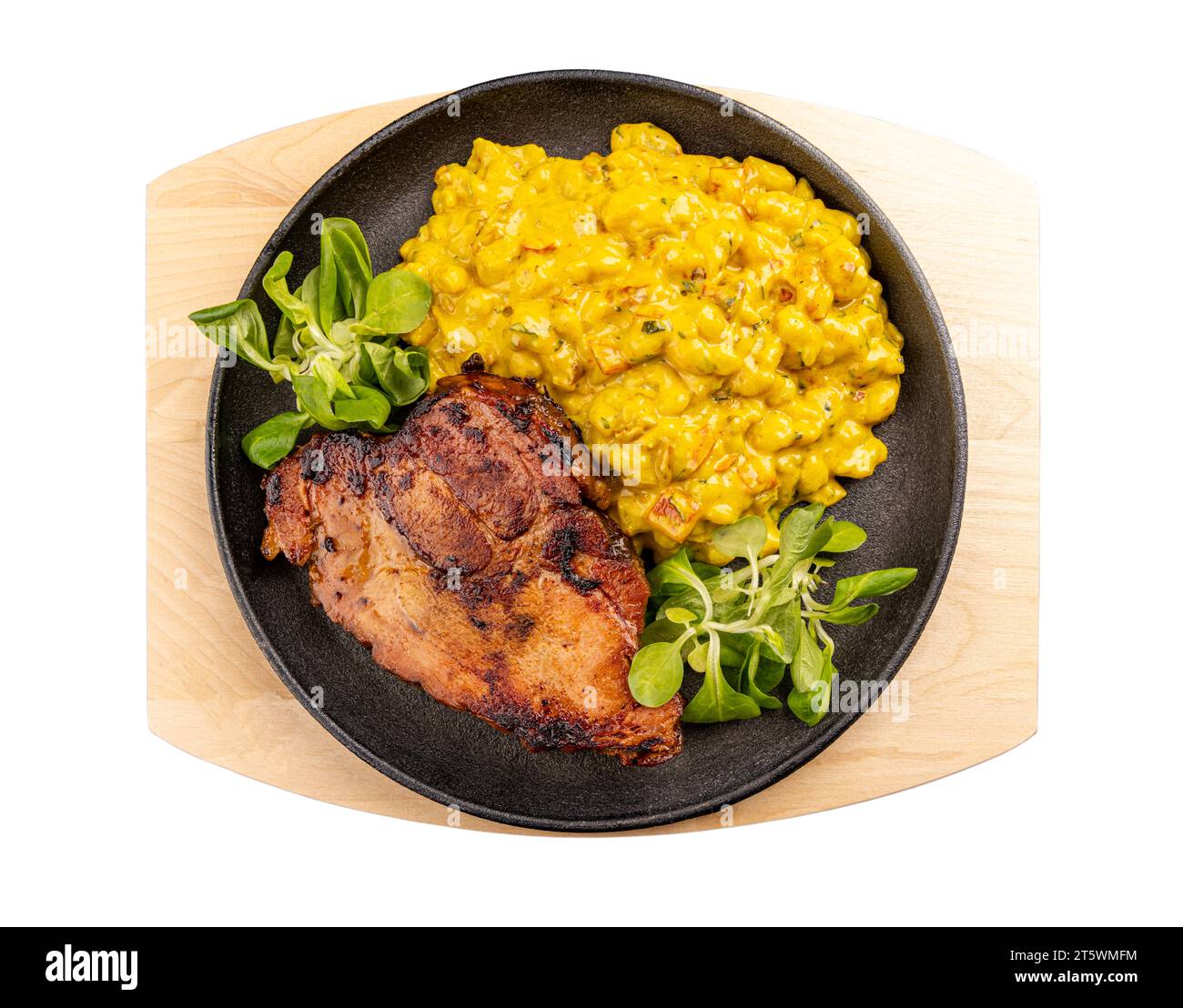 Grilled pork chop or cutlet served with homemade small gnocchi in cream sauce Stock Photo