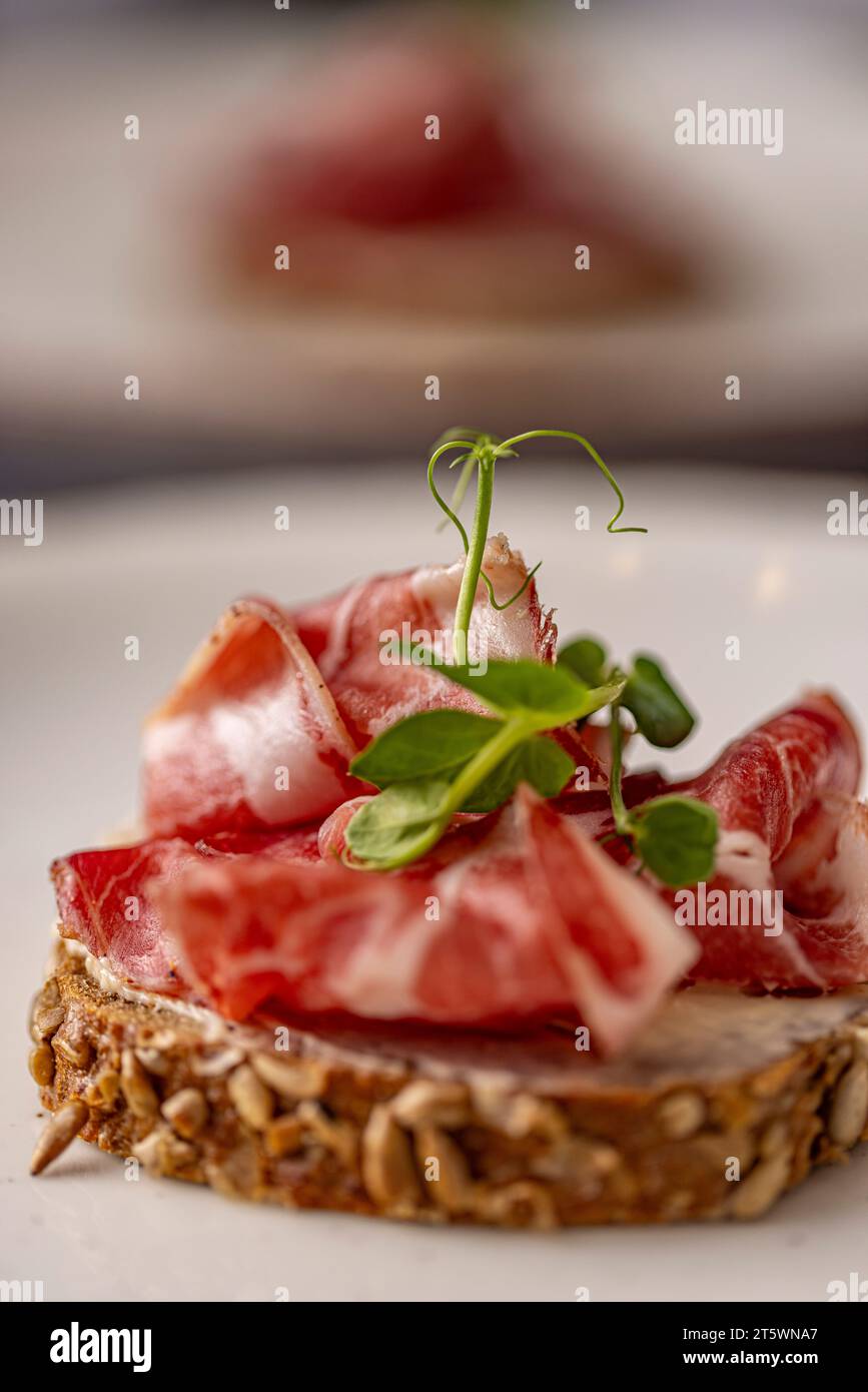 Smoked bacon slices on rye bread, sandwich with prosciutto Stock Photo
