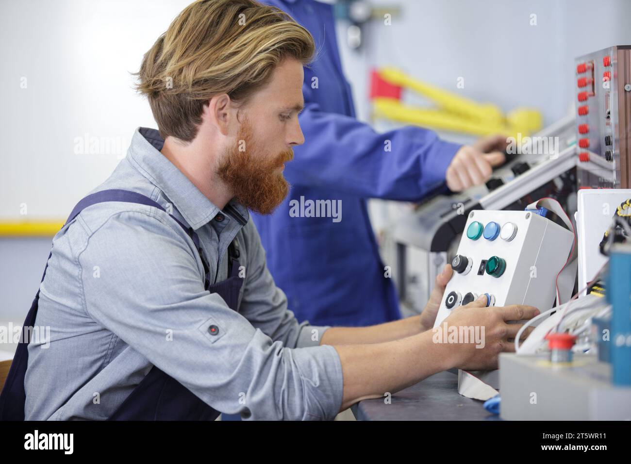 a man is operating machine Stock Photo