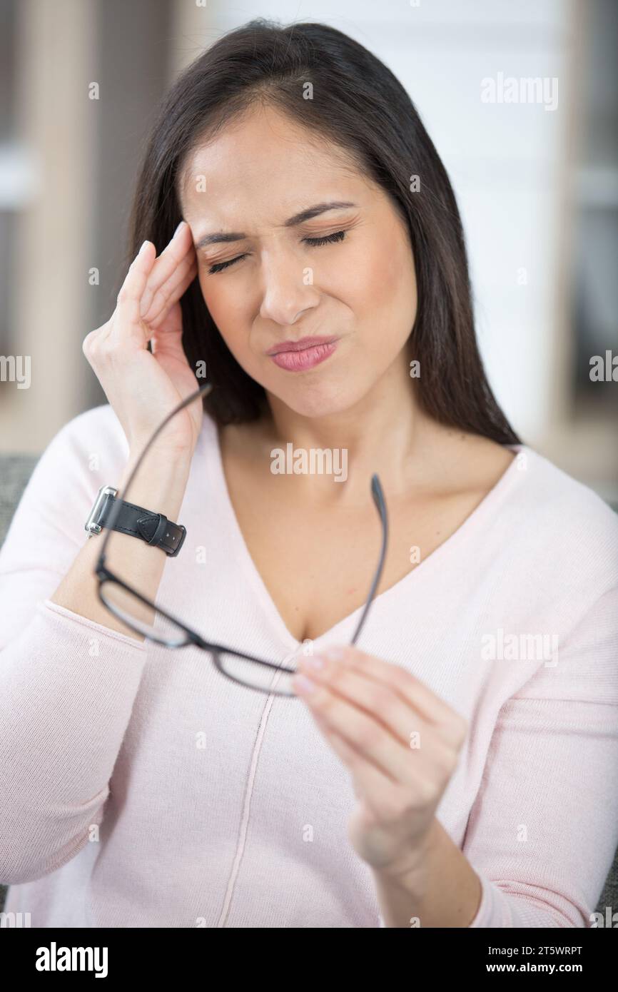 woman having headache at home Stock Photo