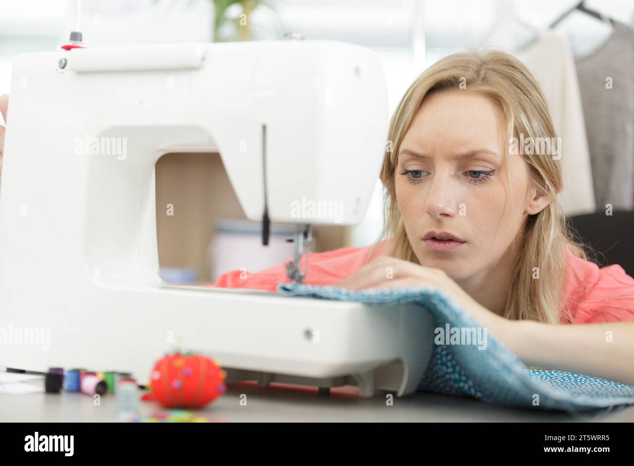 young woman on sewing process Stock Photo - Alamy