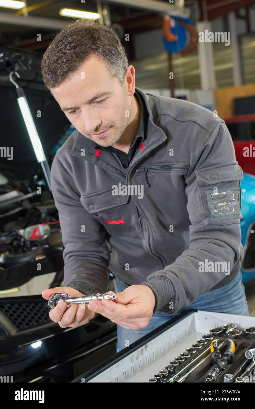 worker builder searching tools in toolbox Stock Photo
