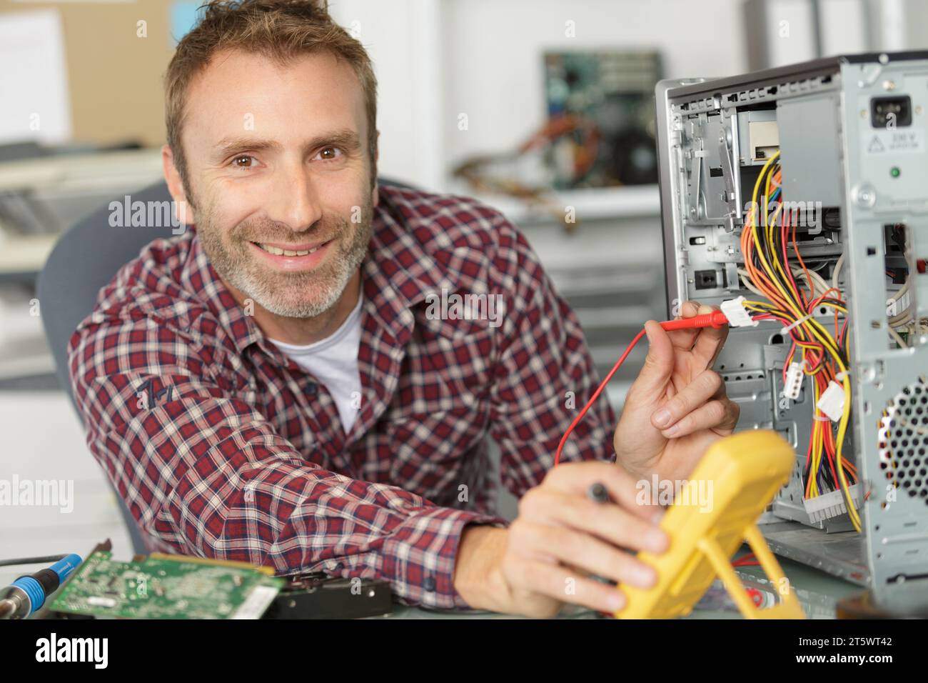 electronic engineer checks digital multimeter indicators Stock Photo