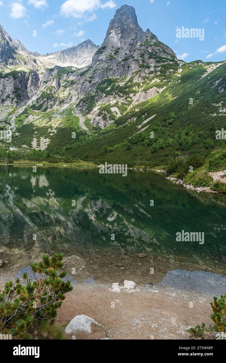 Zelene pleso lake with Jastrabia veza and Kolovy stit mountain peak above in High Tatras mountains in Slovakia during beautiful summer day Stock Photo