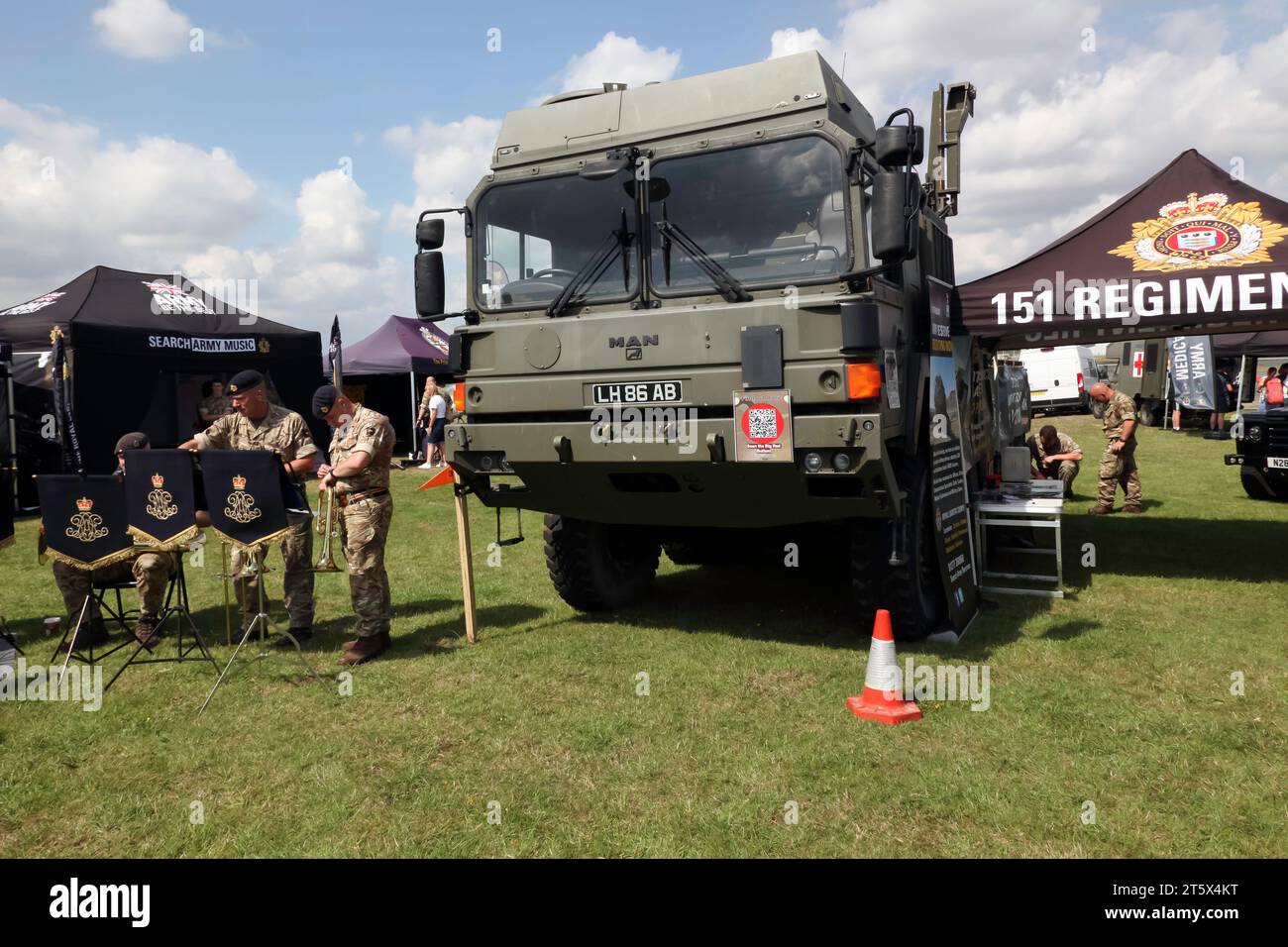 151 Regiment The Royal Logistic Corps and one of their MAN Support vehicles, next to some Army Musicians, at the 2023 British Motor Show Stock Photo