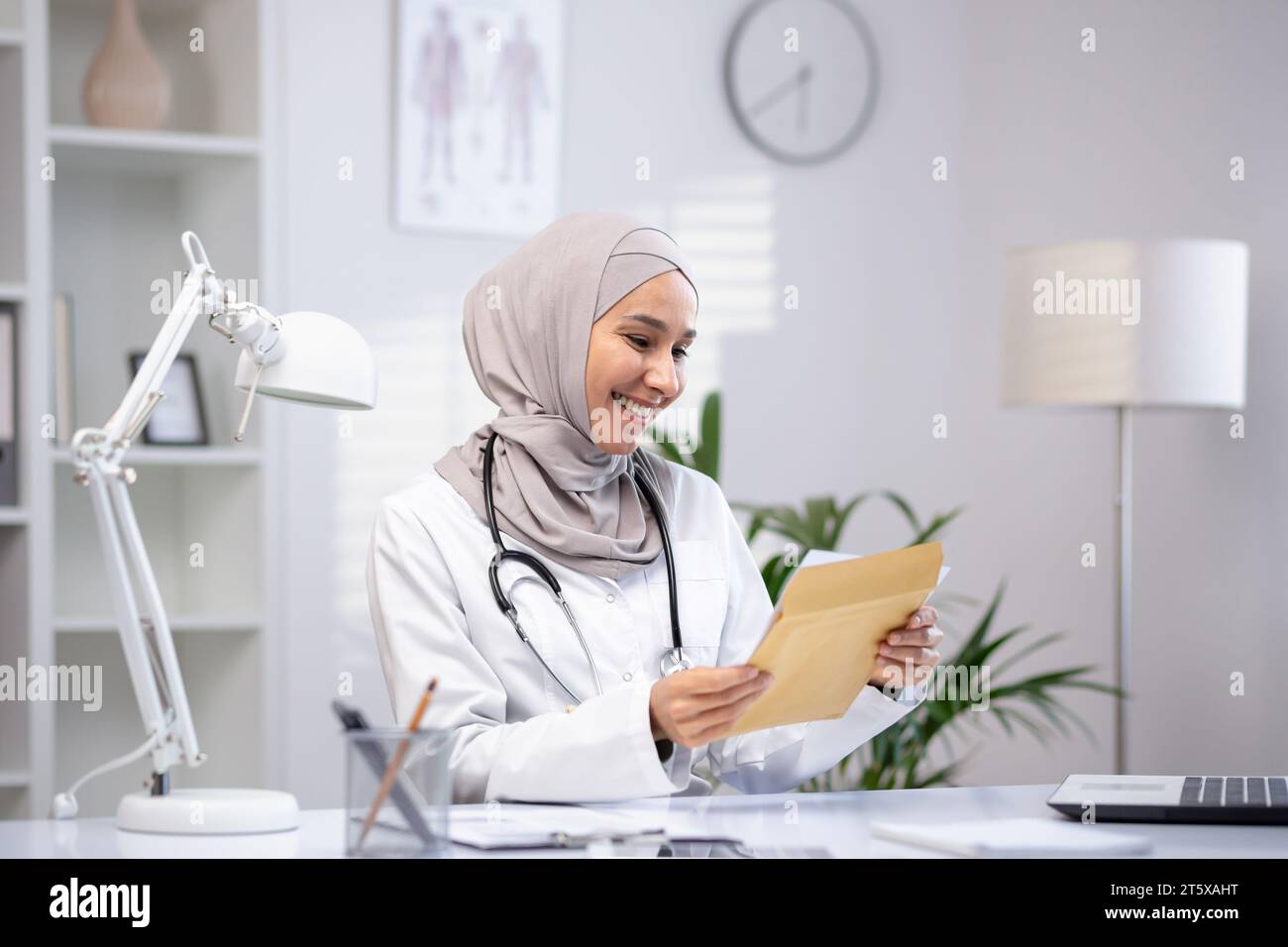 Happy excited female doctor read hi-res stock photography and images ...