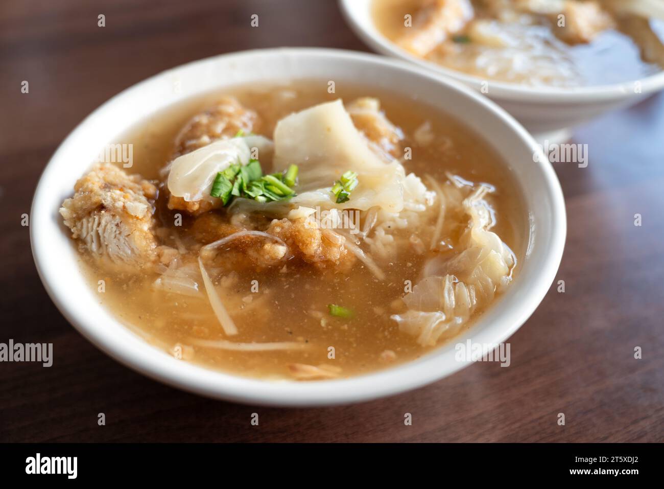 Delicious fried narrow-barred Spanish mackerel fish fillet with rice and noodles in thick soup in Tainan, Taiwan. Stock Photo
