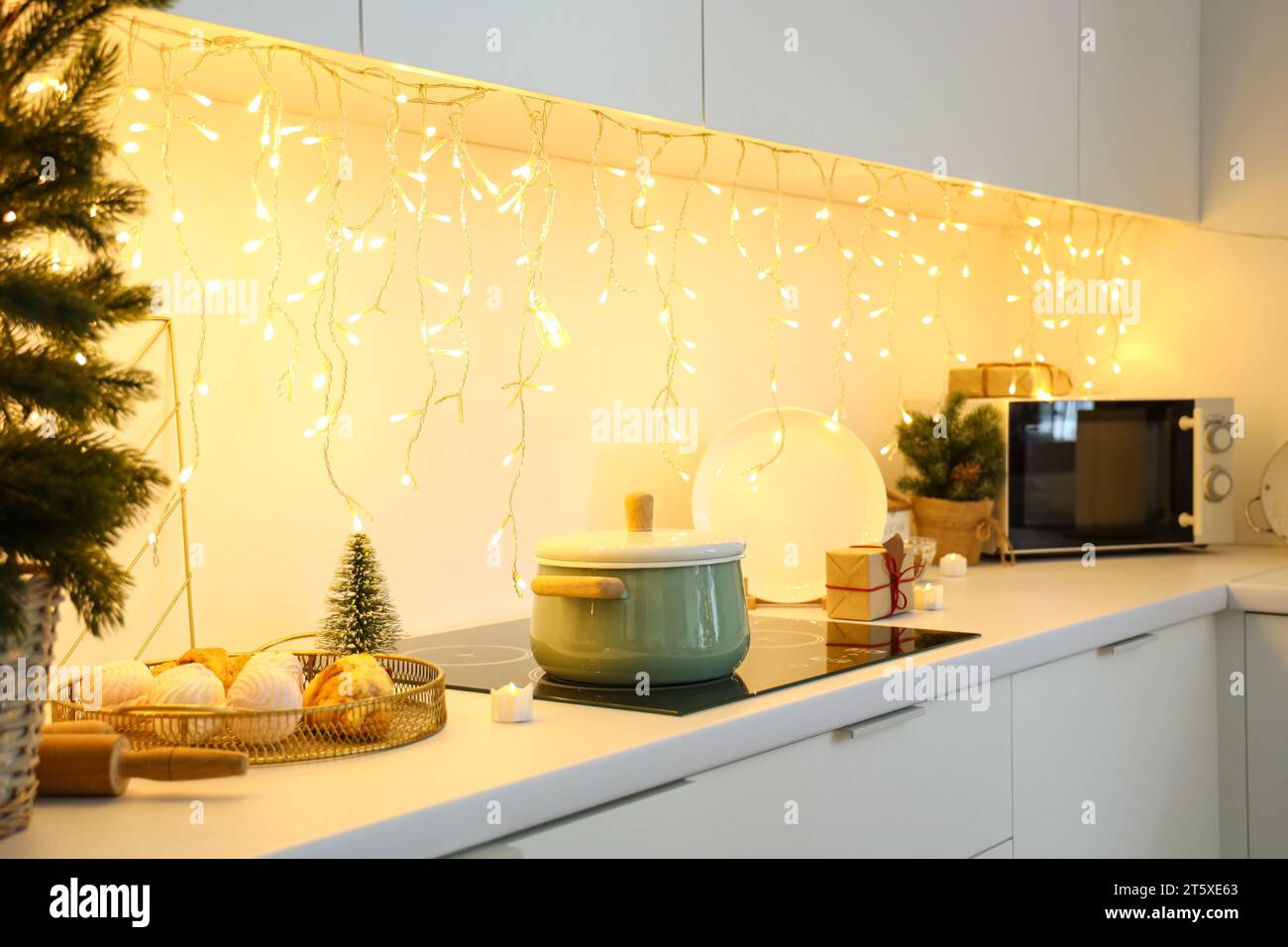 Interior of kitchen with counters and Christmas lights Stock Photo - Alamy