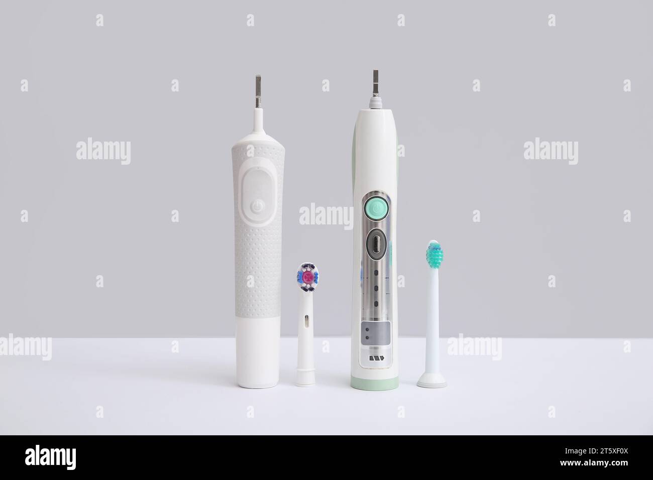 Electric toothbrushes on white background Stock Photo - Alamy