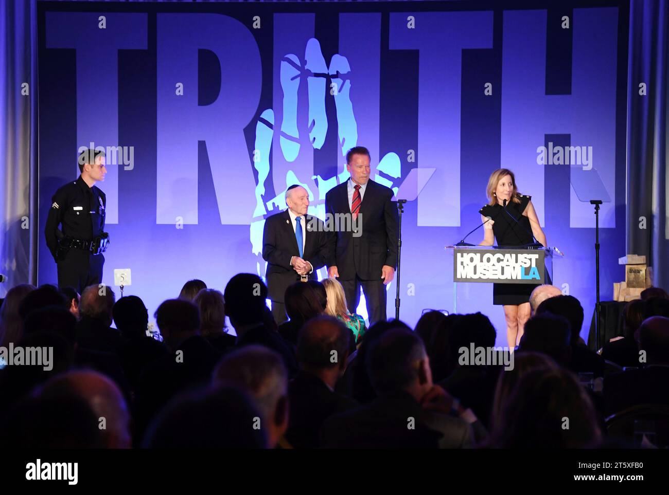 Beverly Hills, California, USA. 06th Nov, 2023. (L-R) LAPD's Gabe Kaplan, 101-year-old Holocaust survivor Joe Alexander, Arnold Schwarzenegger and Holocaust Museum LA CEO Beth Kean onstage during the Holocaust Museum LA gala after being honored with first Award of Courage at The Beverly Hills Hotel on November 06, 2023 in Beverly Hills, California. Credit: Jeffrey Mayer/Jtm Photos/Media Punch/Alamy Live News Stock Photo