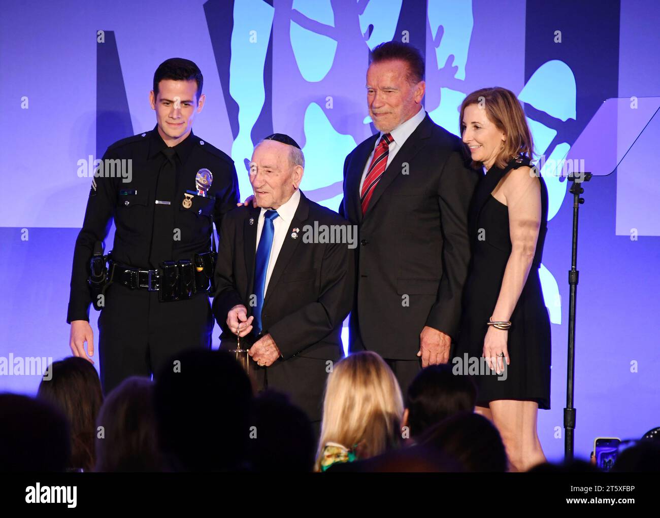 Beverly Hills, California, USA. 06th Nov, 2023. (L-R) LAPD's Gabe Kaplan, 101-year-old Holocaust survivor Joe Alexander, Arnold Schwarzenegger and Holocaust Museum LA CEO Beth Kean onstage during the Holocaust Museum LA gala after being honored with first Award of Courage at The Beverly Hills Hotel on November 06, 2023 in Beverly Hills, California. Credit: Jeffrey Mayer/Jtm Photos/Media Punch/Alamy Live News Stock Photo