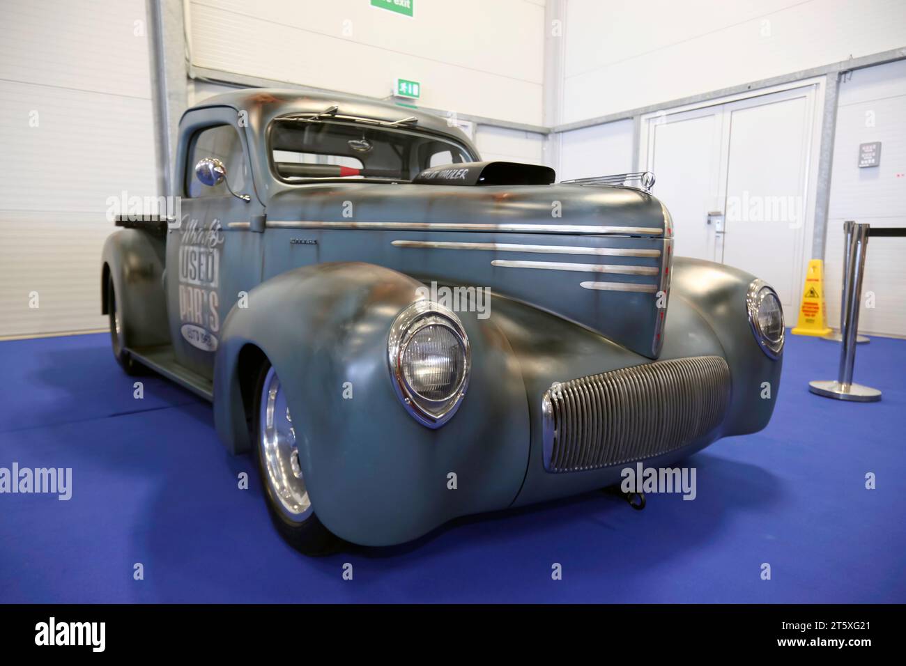 Three-quarters front view of an American,  Customized, Rat Rod, Classic Pickup Van, on display at the 2023 British Motor Show Stock Photo