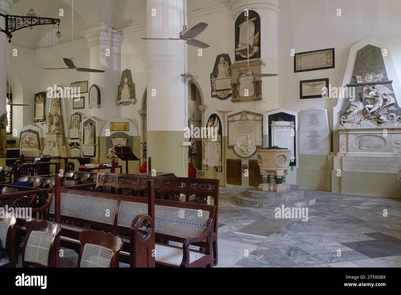 Inside St. Thomas' Cathedral in Fort area, Mumbai, India, with colonial era memorials and memorial plaques to colonial officers along the walls Stock Photo