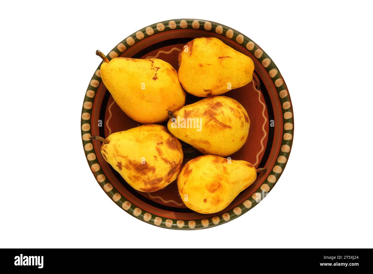 Pears in a clay beige plate. Farm pears in rustic bowl. Isolate on a white background. Top view. Stock Photo