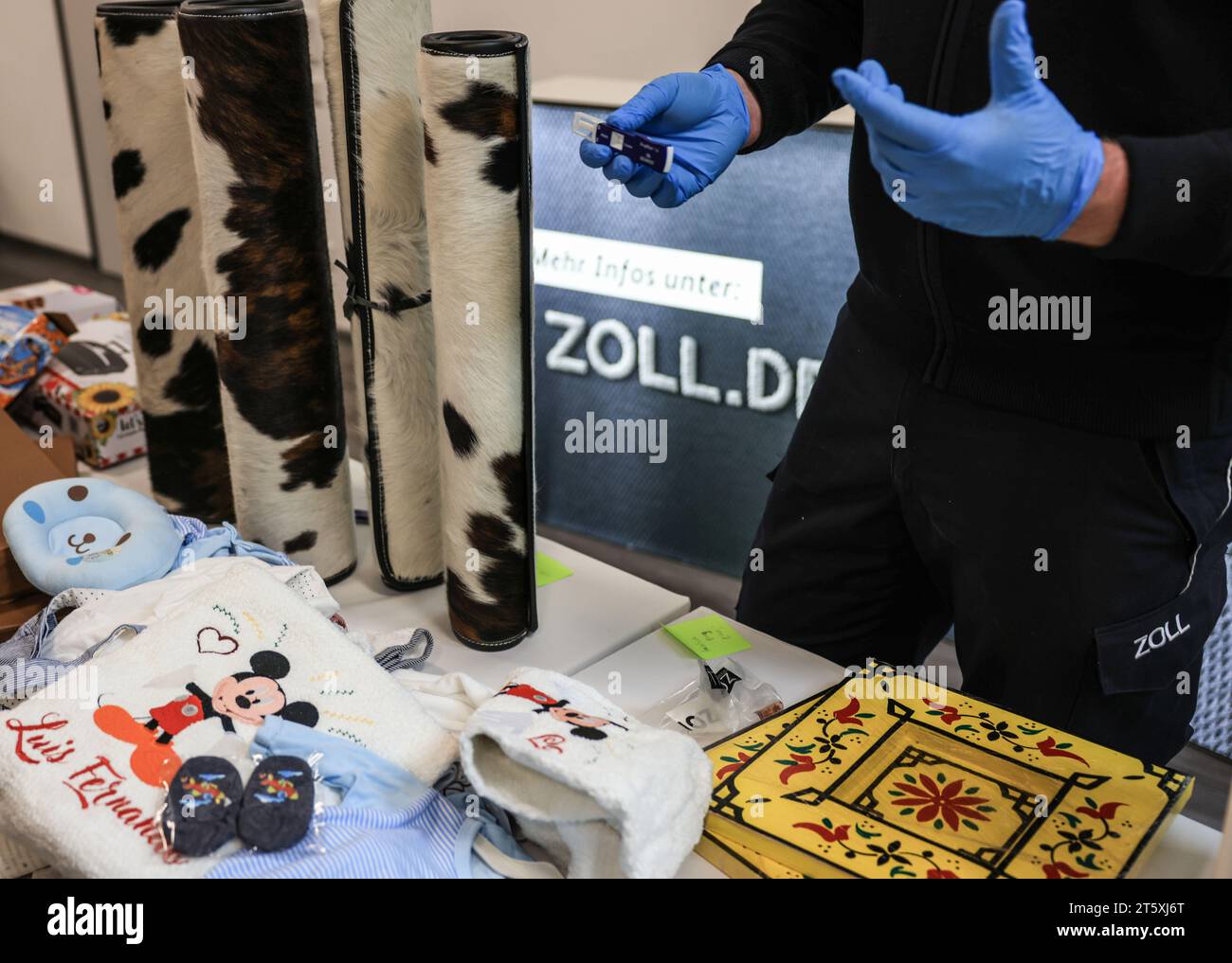 Cologne, Germany. 07th Nov, 2023. An employee of the Cologne Main Customs Office shows a drug testing device behind various drug stashes. The Cologne Main Customs Office has shown unusual drug stashes found in consignments of goods at Cologne/Bonn Airport. Credit: Oliver Berg/dpa/Alamy Live News Stock Photo