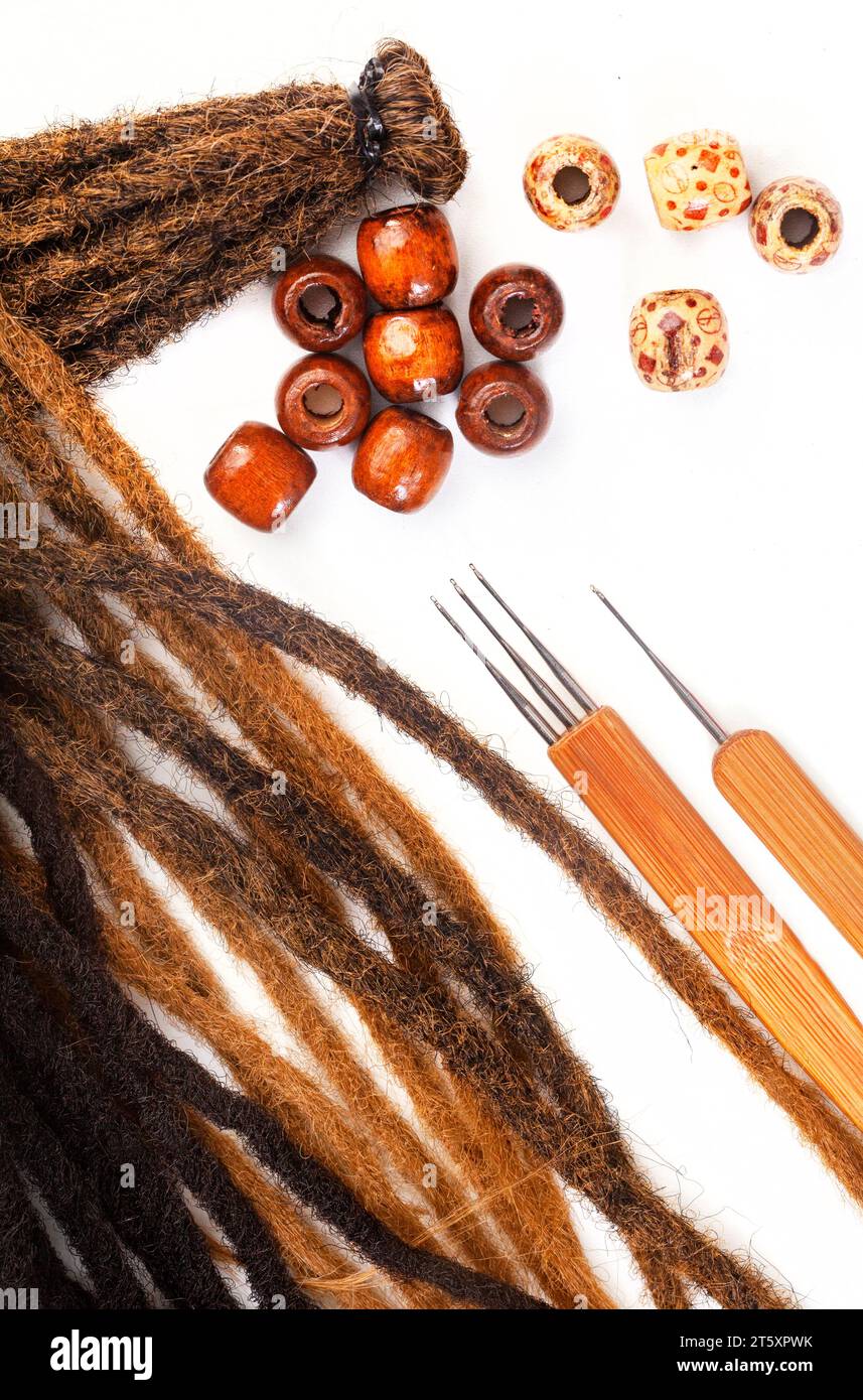 Hair crochet needles and decorative beads for dreadlocks and braids on white Stock Photo